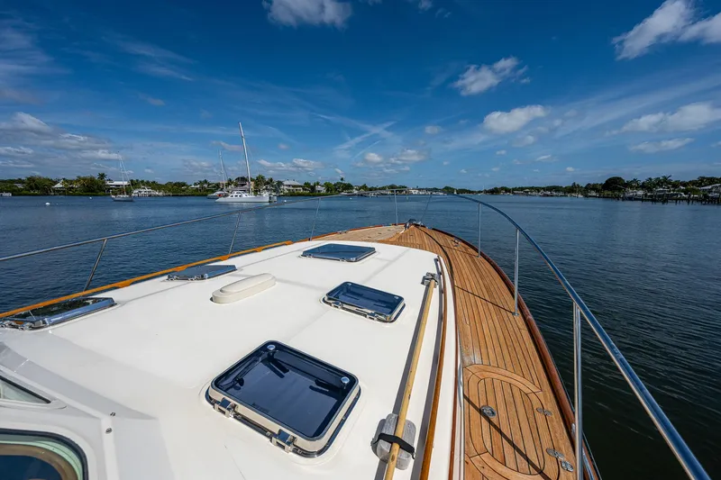 Slide: The Image of 2008 Hinckley Talaria 44 FB yacht on calm water under blue sky. - 34