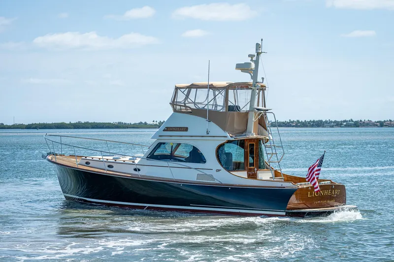 Slide: The Image of 2008 Hinckley Talaria 44 FB yacht cruising on open water with American flag. - 39