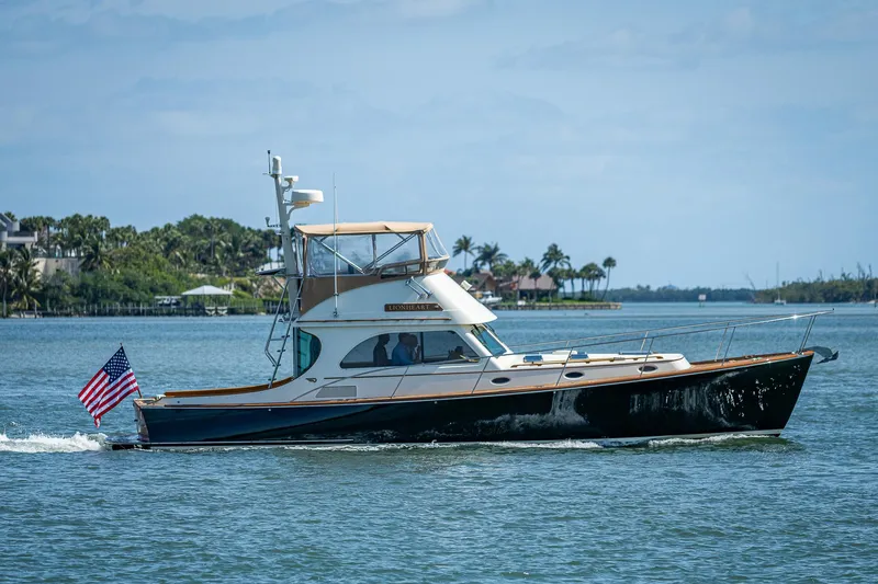 Slide: The Image of 2008 Hinckley Talaria 44 FB yacht cruising on a sunny day with American flag. - 40