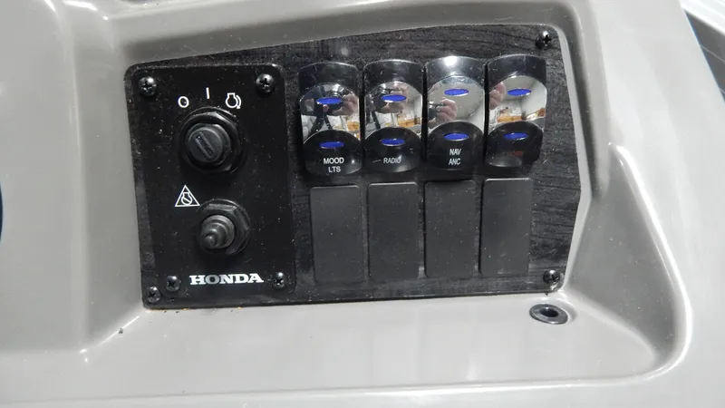Slide: The Image of Control panel of 2024 Avalon VLS Quad Lounge 23' boat with Honda switches. - 10