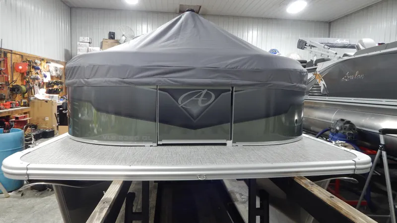 Slide: The Image of 2024 Avalon VLS Quad Lounge 23' pontoon boat in a storage facility. - 3