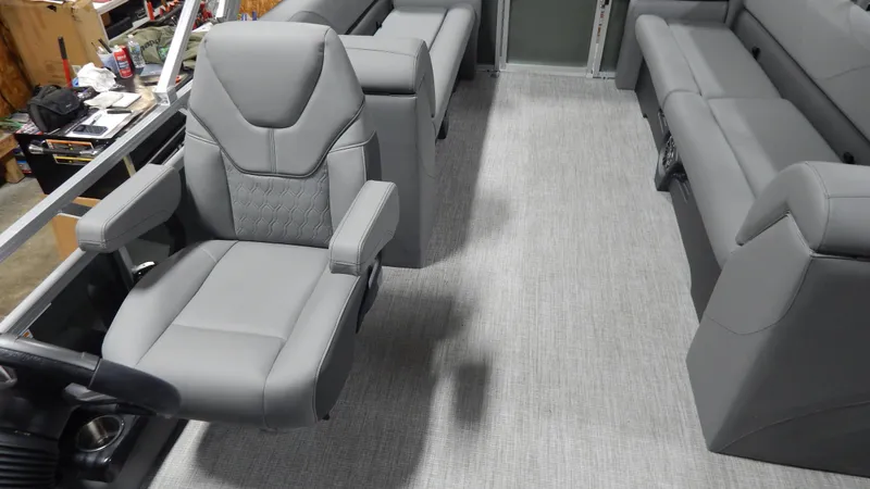 Slide: The Image of 2024 Avalon VLS Quad Lounge 23' interior with gray seating and captain's chair. - 6