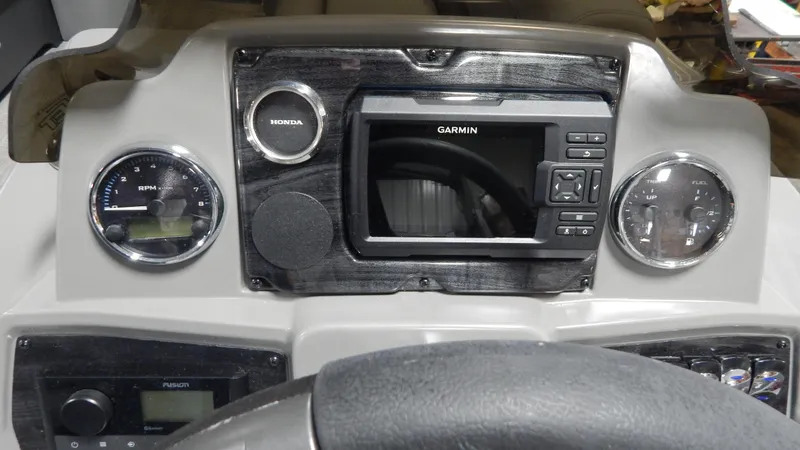 Slide: The Image of 2024 Avalon VLS Quad Lounge 23' dashboard with Garmin navigation system and Honda controls. - 8