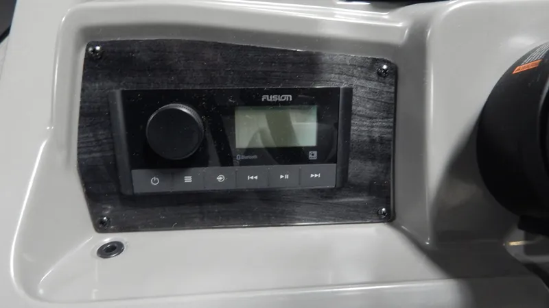 Slide: The Image of 2024 Avalon VLS Quad Lounge 23' boat dashboard with Fusion audio system. - 9