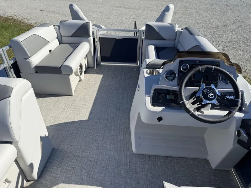 Slide: The Image of 2024 Avalon Venture Cruise Bow Fish boat interior with plush seating and modern dashboard. - 6