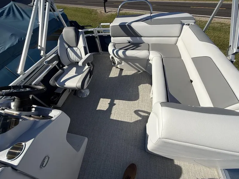 Slide: The Image of 2024 Avalon Venture Cruise Bow Fish boat interior with seating and helm. - 7