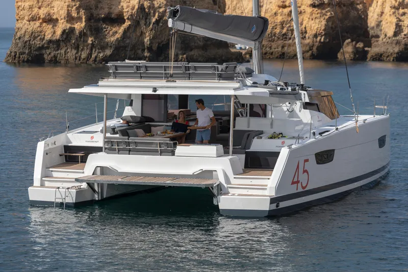 Slide: The Image of 2024 Fountaine Pajot Elba 45 catamaran sailing near rocky cliffs. - 3