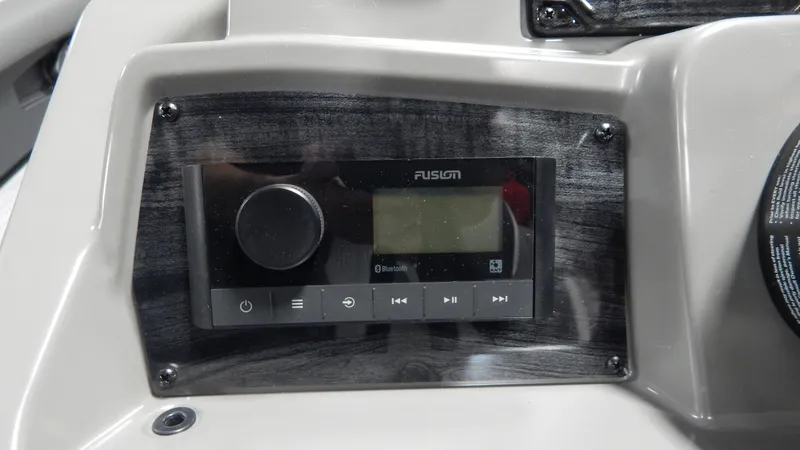 Slide: The Image of 2024 Avalon Venture Cruise Rear Bench 23' boat dashboard with Fusion audio system. - 8