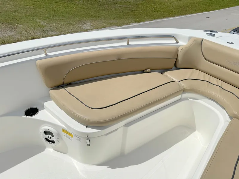 Slide: The Image of 2021 NauticStar 2302 Legacy boat with beige cushioned seating. - 10