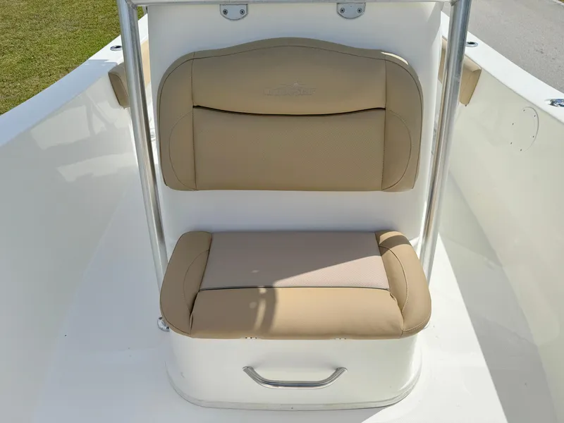 Slide: The Image of 2021 NauticStar 2302 Legacy boat with beige cushioned seating. - 11