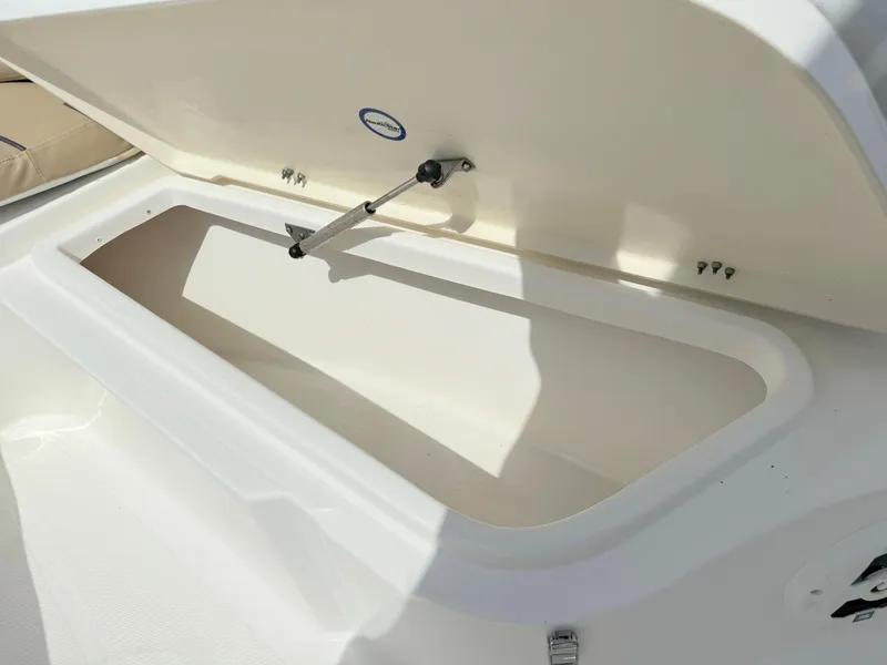 Slide: The Image of Open storage compartment on a 2021 NauticStar 2302 Legacy boat. - 12