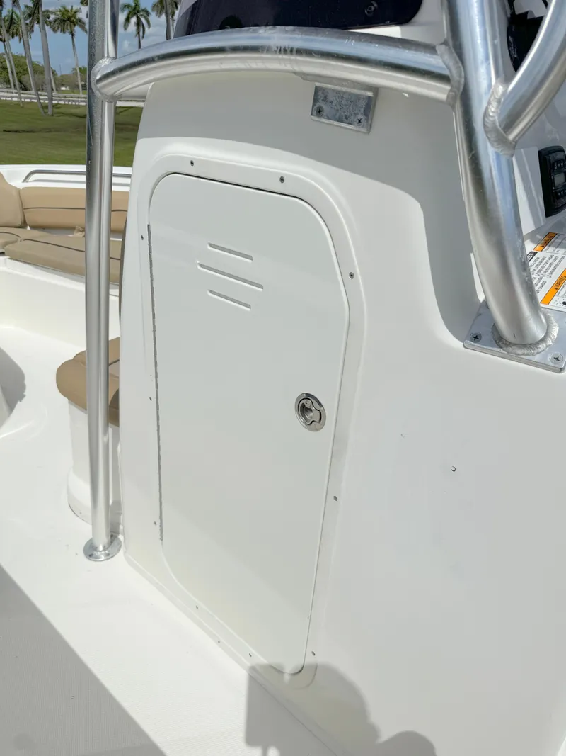Slide: The Image of 2021 NauticStar 2302 Legacy boat console with storage compartment. - 14