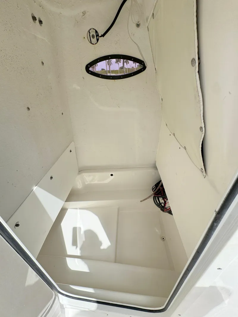 Slide: The Image of Interior cabin of 2021 NauticStar 2302 Legacy boat with small window. - 15