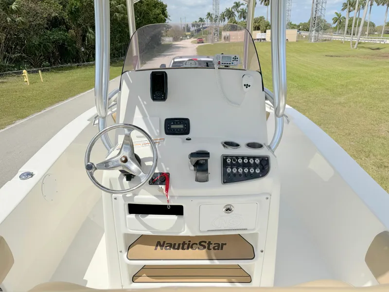 Slide: The Image of 2021 NauticStar 2302 Legacy boat console with steering wheel and control panel. - 18