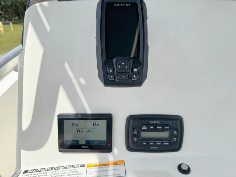 Slide: The Image of 2021 NauticStar 2302 Legacy dashboard with Garmin and Yamaha displays. - 20