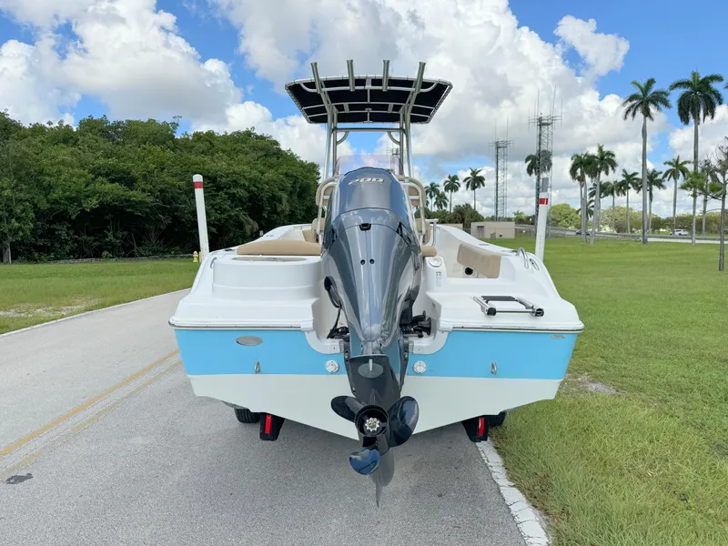 Slide: The Image of 2021 NauticStar 2302 Legacy boat with outboard motor on a road. - 3