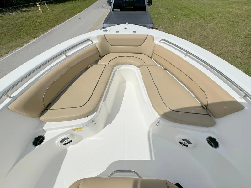 Slide: The Image of 2021 NauticStar 2302 Legacy boat with tan cushioned seating in the bow. - 7