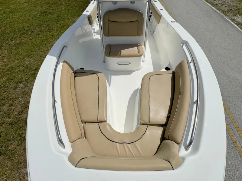 Slide: The Image of 2021 NauticStar 2302 Legacy boat with tan cushioned seating. - 8
