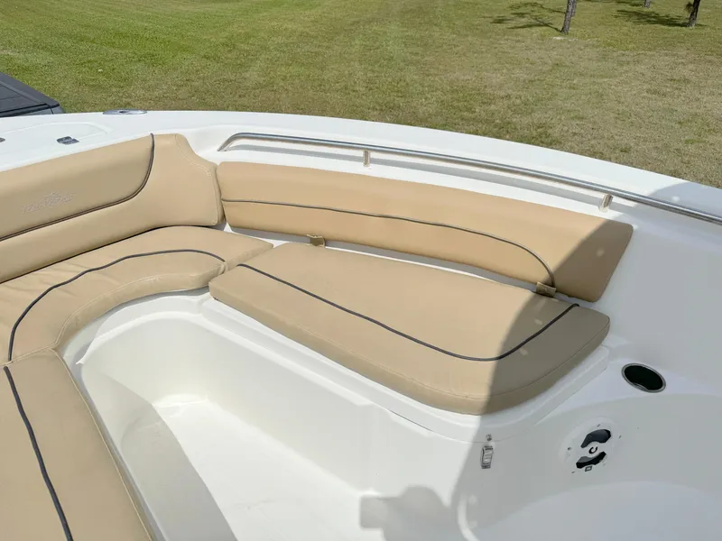 Slide: The Image of 2021 NauticStar 2302 Legacy boat with beige cushioned seating. - 9