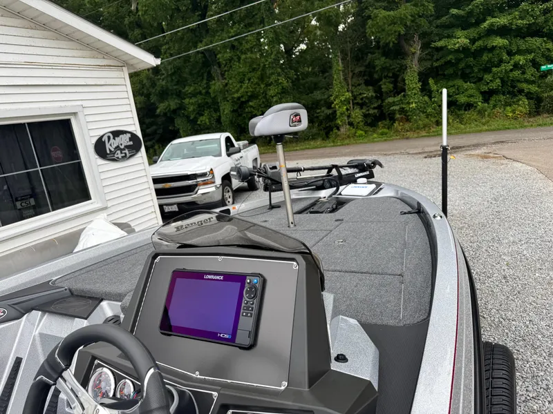 Slide: The Image of 2024 Ranger Z519C boat with advanced navigation system, parked near a dealership. - 6