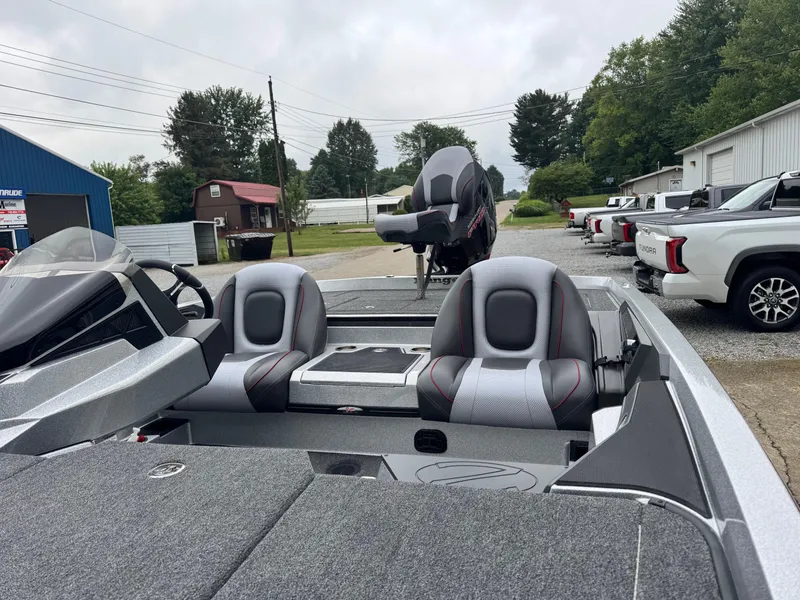 Slide: The Image of 2024 Ranger Z519C boat with dual seats, parked outdoors near trucks. - 9