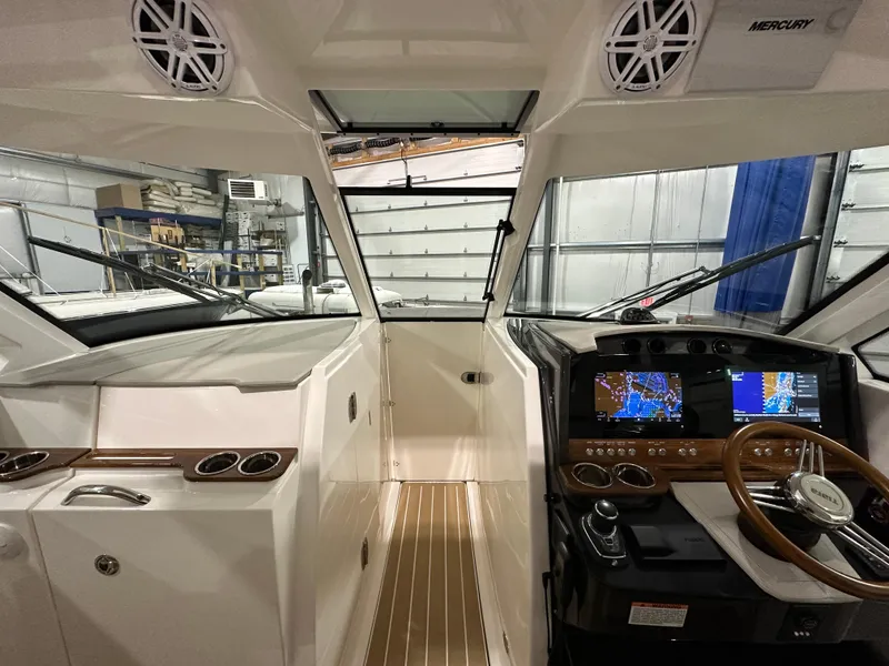 Slide: The Image of 2024 Tiara Yachts 34 LX helm with modern navigation displays and luxurious interior. - 17