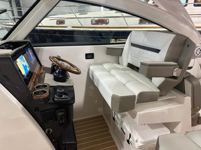 Slide: The Image of 2024 Tiara Yachts 34 LX helm with luxurious seating and advanced navigation system. - 18