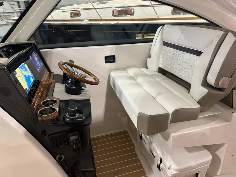 Slide: The Image of 2024 Tiara Yachts 34 LX helm with leather seating and modern navigation controls. - 19