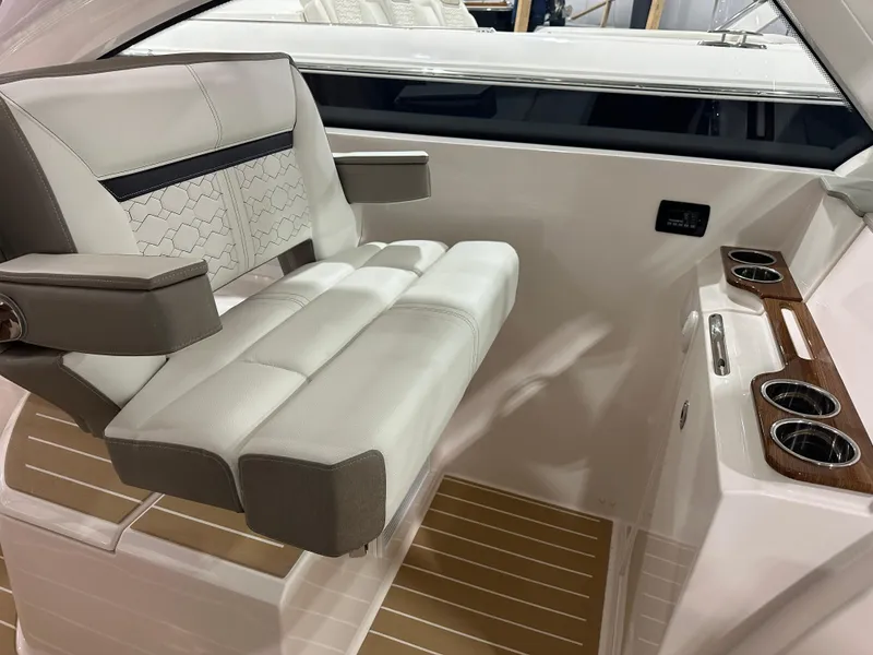 Slide: The Image of 2024 Tiara Yachts 34 LX interior with luxurious seating and cup holders. - 22