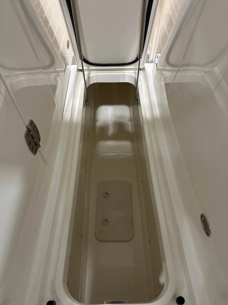 Slide: The Image of 2024 Tiara Yachts 34 LX storage compartment, open and empty, showcasing interior space. - 23