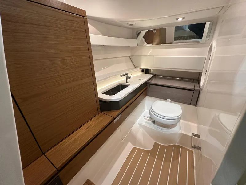Slide: The Image of 2024 Tiara Yachts 34 LX bathroom with modern fixtures and wood accents. - 25