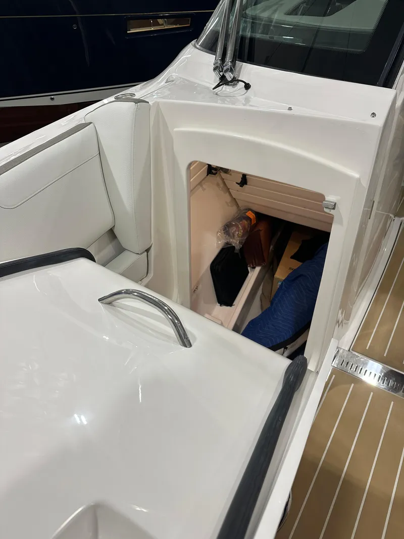 Slide: The Image of 2024 Tiara Yachts 34 LX interior cabin view with sleek white design. - 27