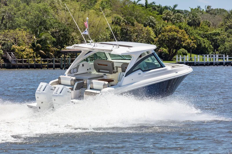 Slide: The Image of 2024 Tiara Yachts 34 LX cruising on a scenic waterway. - 3