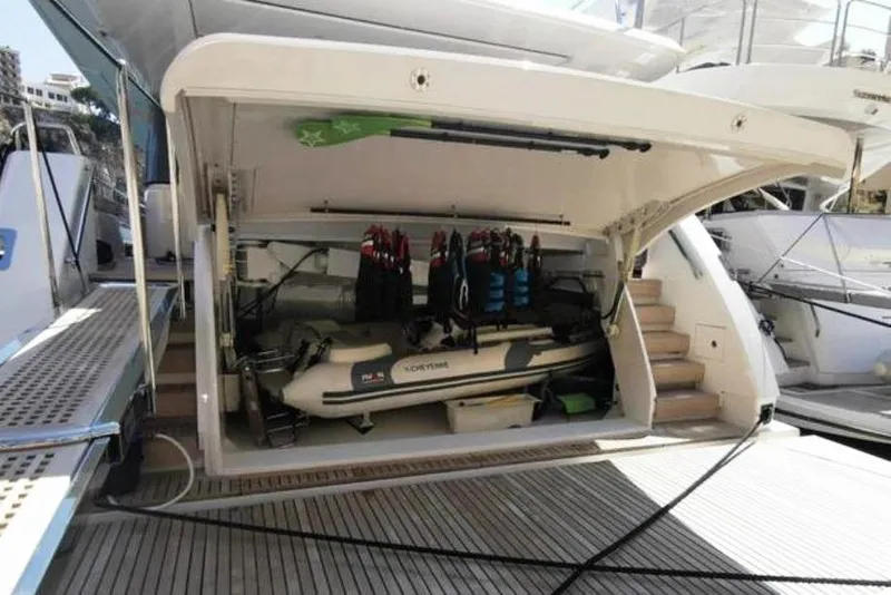 Slide: The Image of Sanlorenzo SL96 2016 yacht with open garage, showing stored equipment and tender. - 13