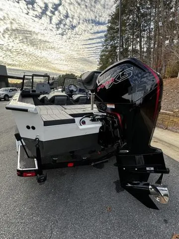 Slide: The Image of 2024 Vexus ADX180 boat with powerful outboard motor, docked on a sunny day. - 4