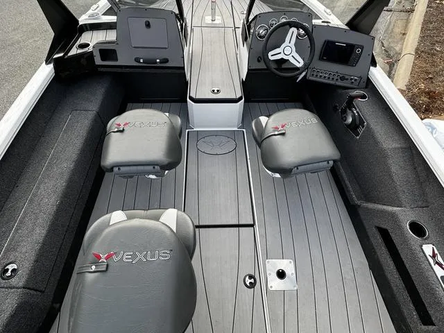 Slide: The Image of 2024 Vexus ADX180 boat interior with steering console and seating. - 6