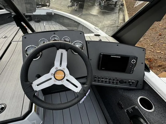 Slide: The Image of 2024 Vexus ADX180 boat dashboard with steering wheel and electronic controls. - 7