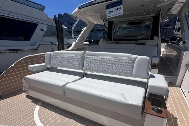 Slide: The Image of 2024 Tiara Yachts 48 LS luxury seating area on deck, docked at marina. - 11