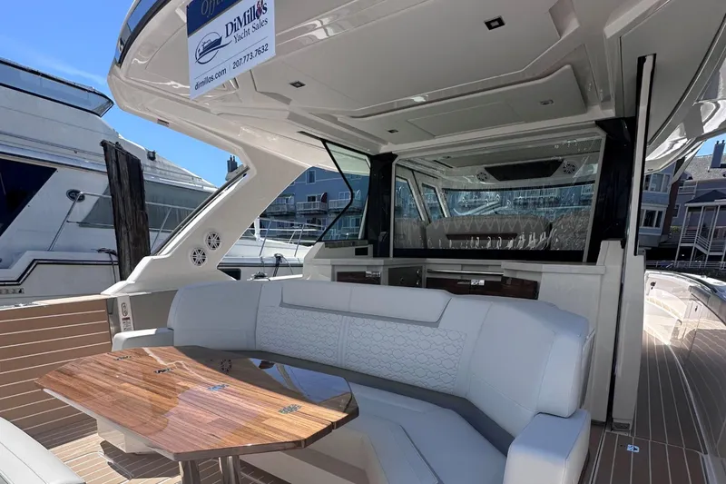 Slide: The Image of 2024 Tiara Yachts 48 LS luxury boat interior with seating and wooden table. - 13