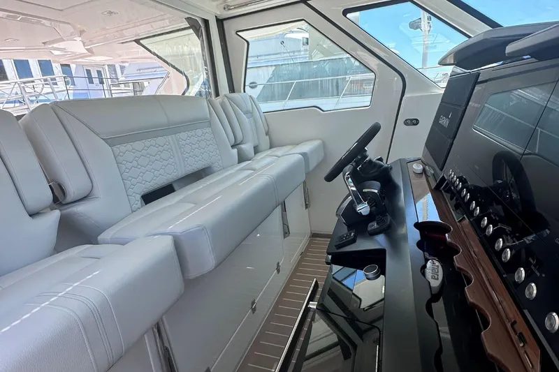 Slide: The Image of Interior of 2024 Tiara Yachts 48 LS, featuring luxurious seating and modern helm controls. - 18