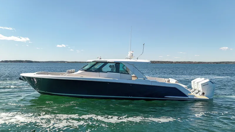 Slide: The Image of 2024 Tiara Yachts 48 LS luxury boat cruising on open water. - 2