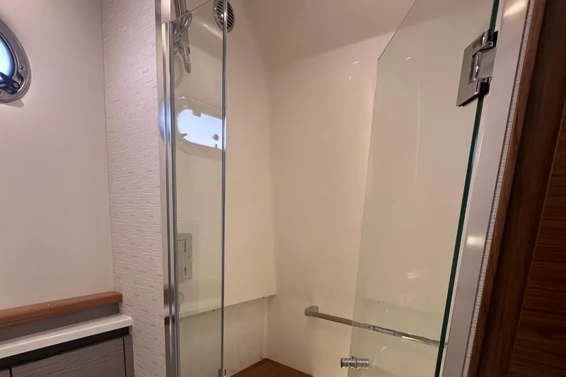 Slide: The Image of Modern bathroom in 2024 Tiara Yachts 48 LS with glass shower enclosure. - 26