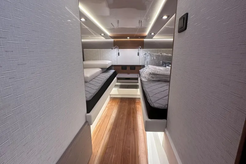 Slide: The Image of 2024 Tiara Yachts 48 LS cabin with twin beds and modern lighting. - 27