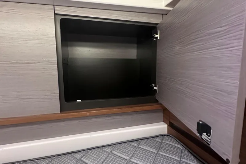 Slide: The Image of Open storage compartment in 2024 Tiara Yachts 48 LS, featuring modern wood finish. - 30