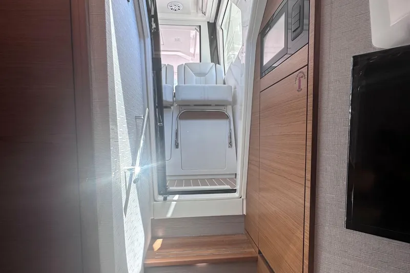 Slide: The Image of Interior view of 2024 Tiara Yachts 48 LS, featuring modern seating and wooden finishes. - 35
