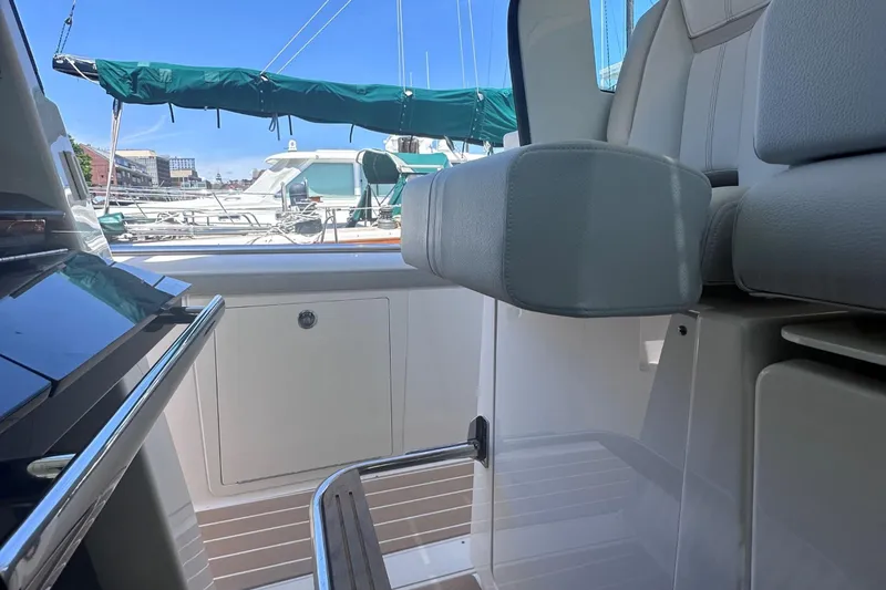 Slide: The Image of 2024 Tiara Yachts 48 LS interior with marina view in background. - 38