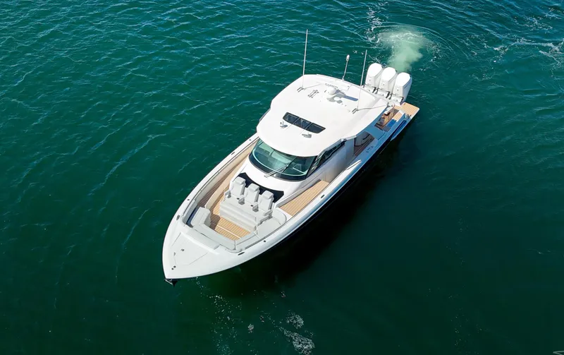Slide: The Image of 2024 Tiara Yachts 48 LS luxury boat cruising on clear blue water. - 4
