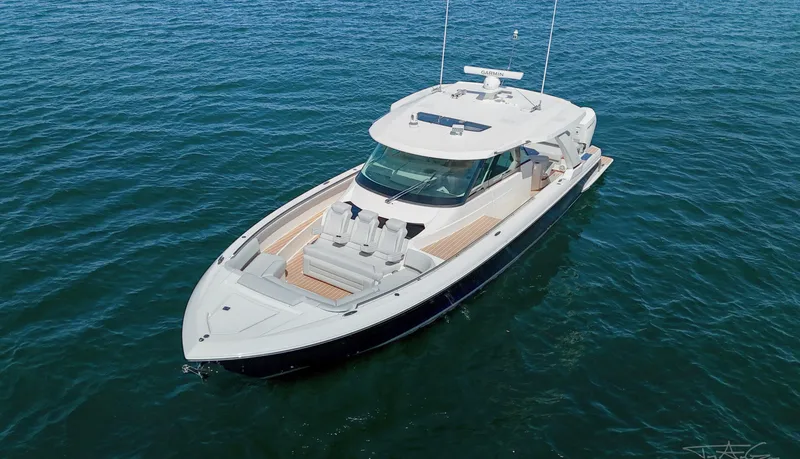 Slide: The Image of 2024 Tiara Yachts 48 LS luxury boat cruising on open water. - 6