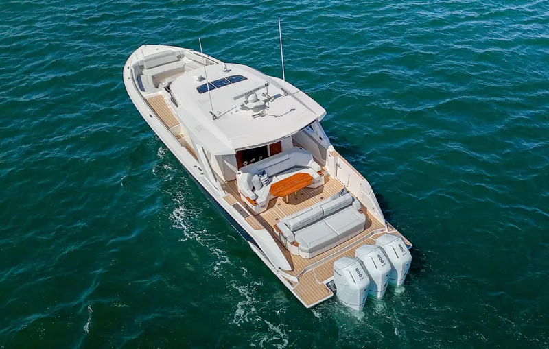 Slide: The Image of 2024 Tiara Yachts 48 LS luxury boat cruising on open water. - 8