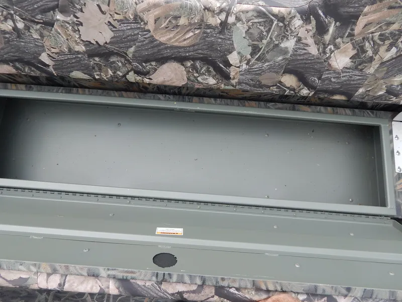 Slide: The Image of 2024 Polar Kraft SPORT X 190 CC boat storage compartment with camouflage interior. - 10